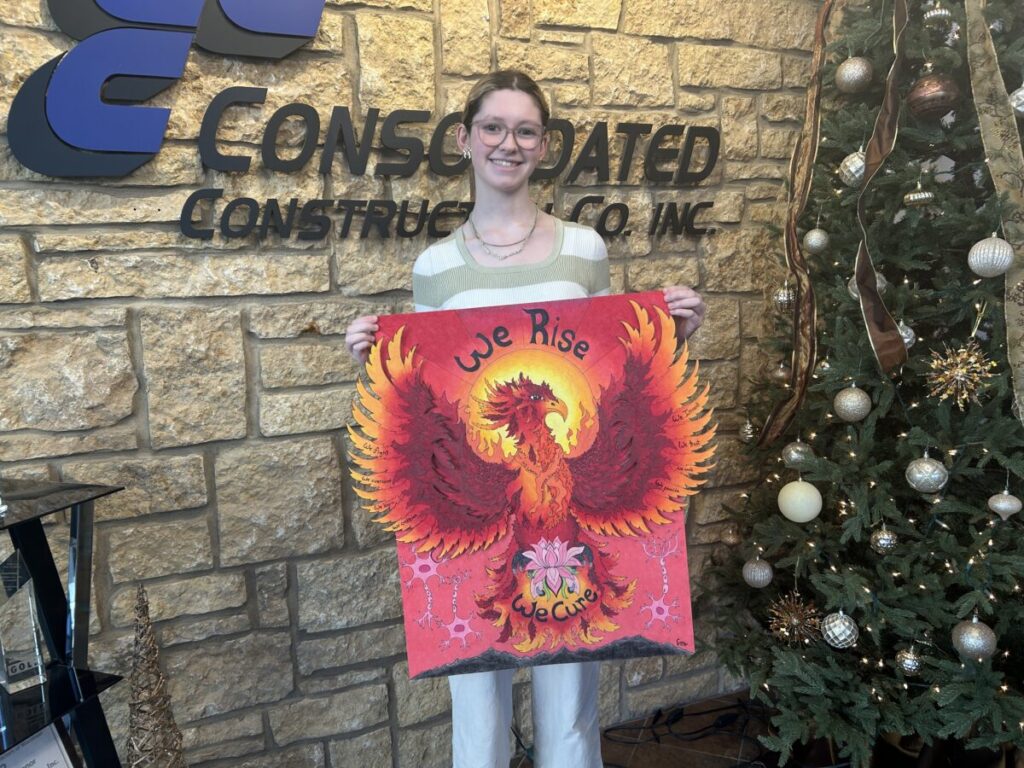 Figure 1: Emily Bakey, senior at Xavier High School, presents her winning artwork “We Rise”, which will represent the 2026 Consolidated for a Cause campaign benefiting the National MS Society.